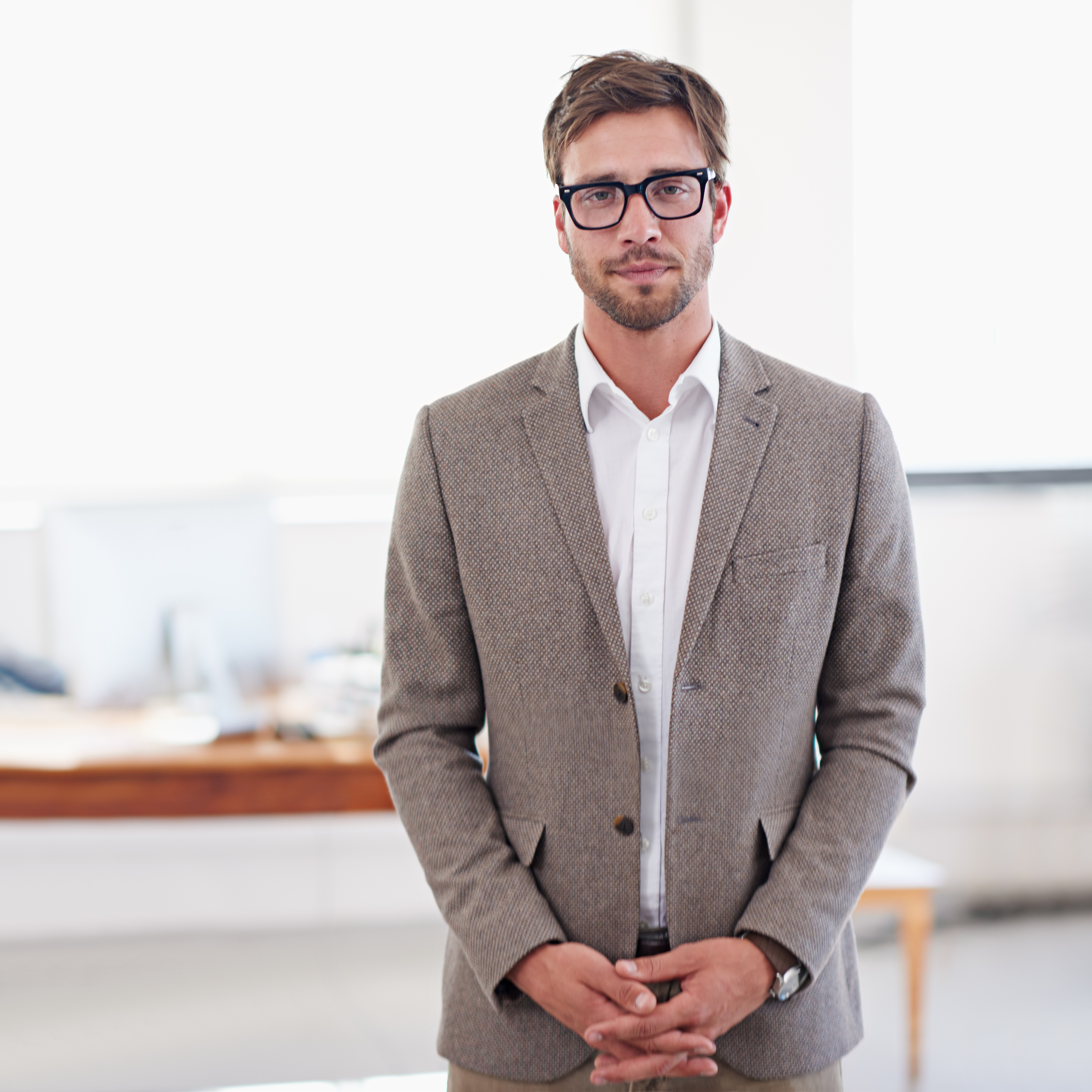 Ready to do business. Shot of a young man standing in an office.